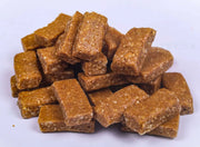 A pile of chocolate-coated puffed rice bars, known as Koko Mittai, on a white background.